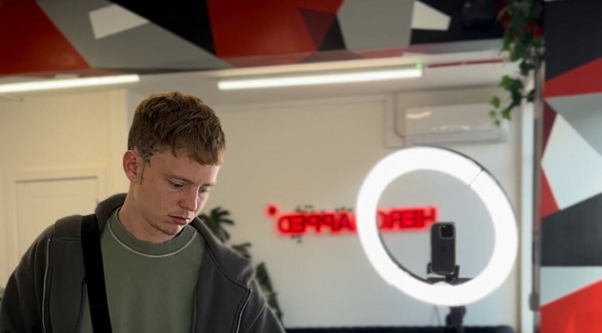 Interior of HeroGapped Barber Studio in Bognor Regis, England with modern decor and a ring light setup.
