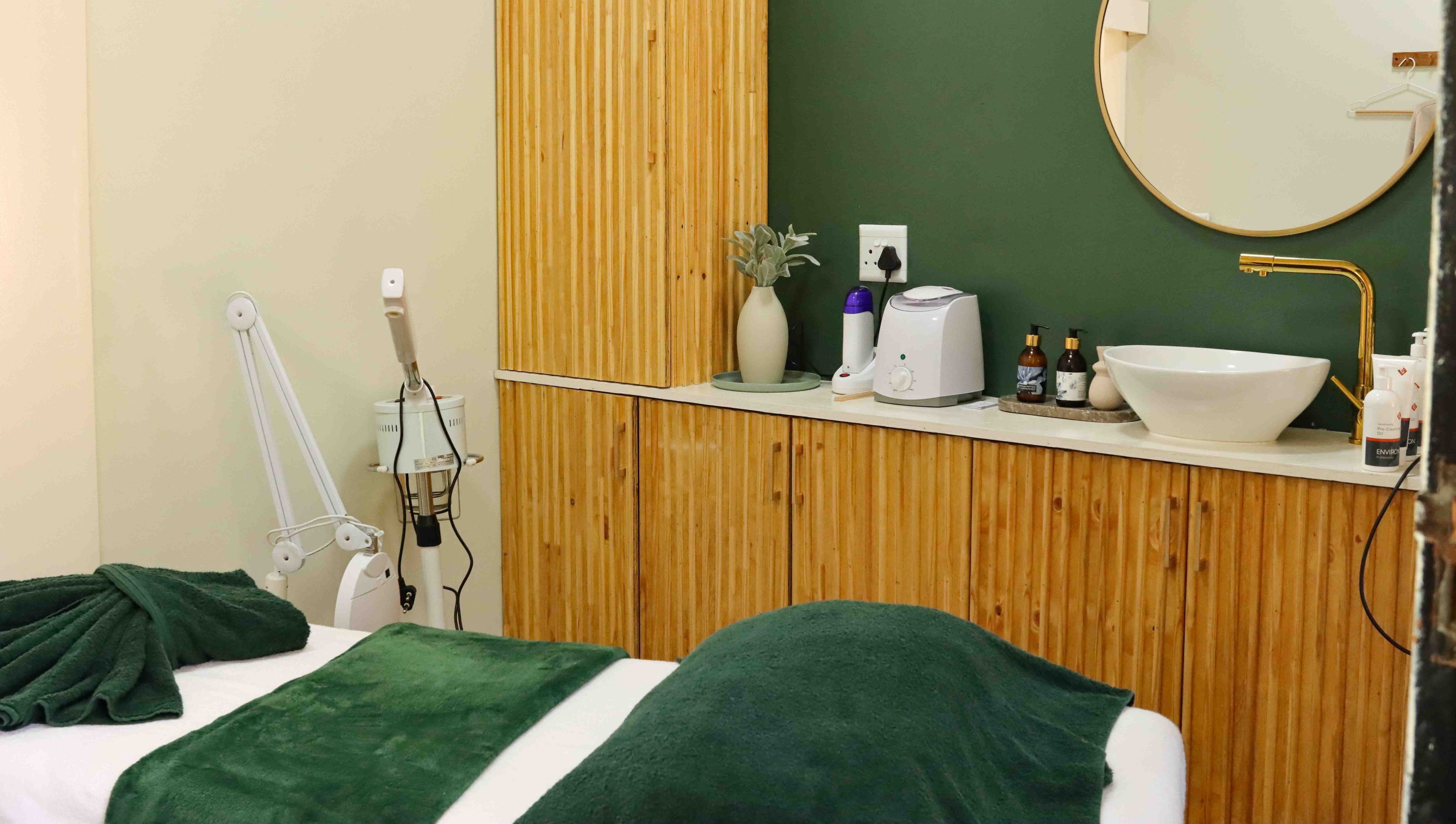 Relaxing treatment room at Umdlalo Wellness, Port Shepstone, Kwazulu-natal, ZA with green accents and modern fixtures.