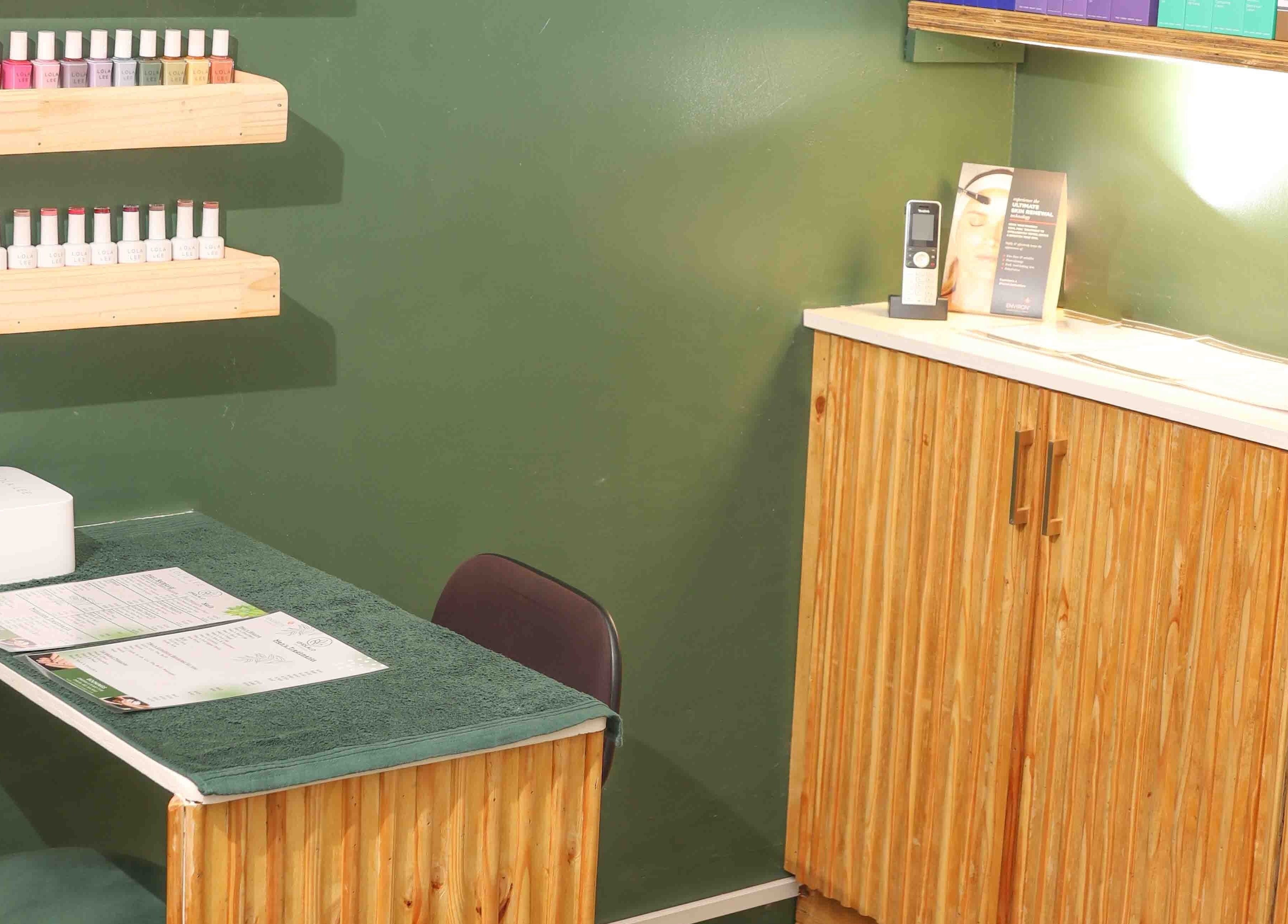 Nail care station at Umdlalo Wellness, Port Shepstone, Kwazulu-natal, ZA with polish display and wooden decor.