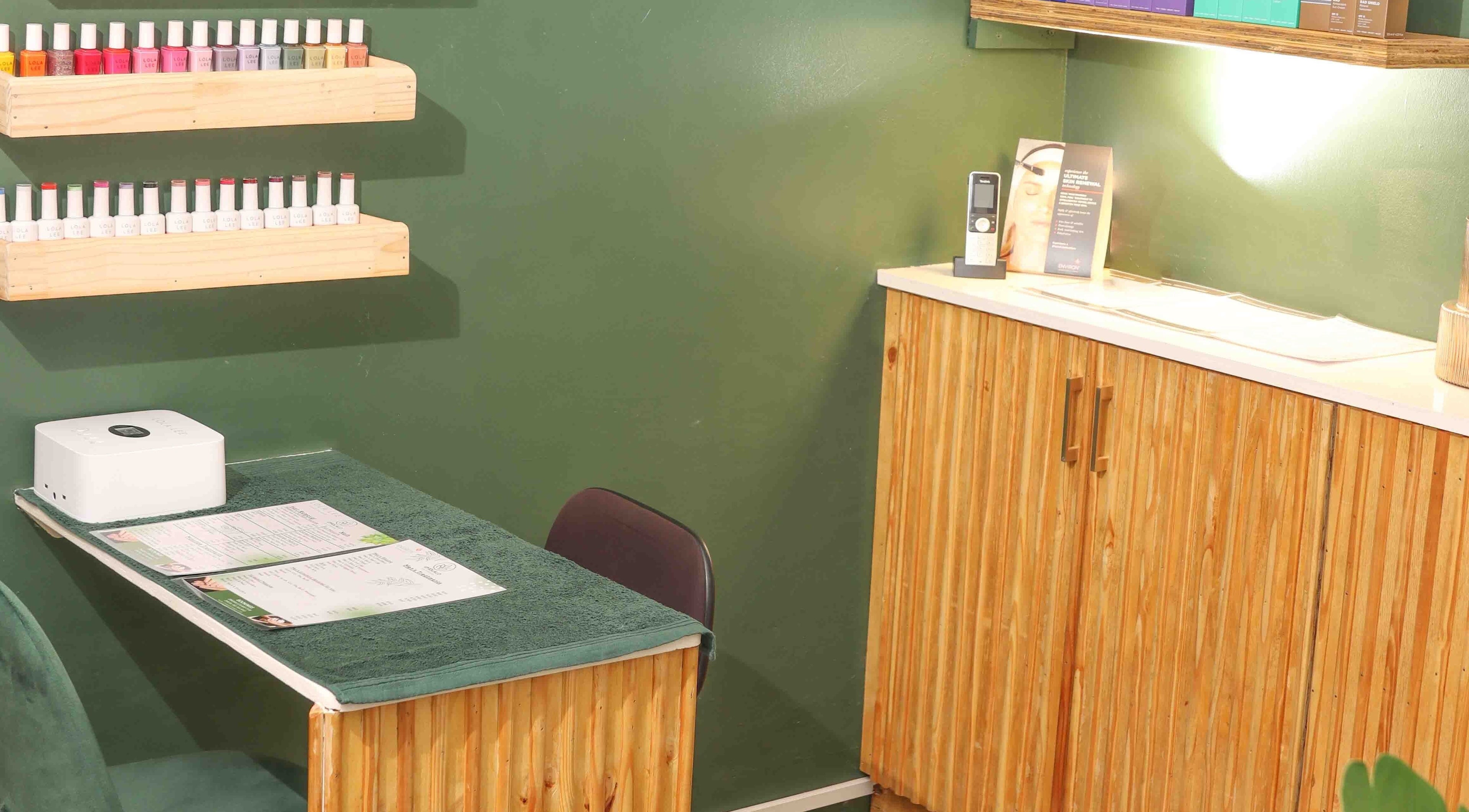 Nail care station at Umdlalo Wellness, Port Shepstone, Kwazulu-natal, ZA with polish display and wooden decor.