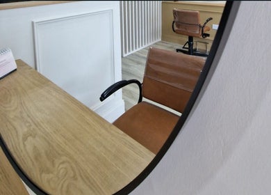 Elegant chair at Aoife Creaby Hair, Westport, County Mayo, IE, reflected in a mirror.