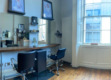 Modern salon setup with stylish chairs at The Hair Artist in Dublin, County Dublin, IE.