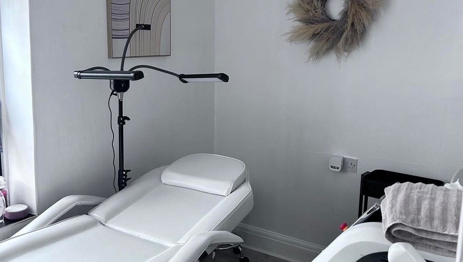 Relaxing treatment room at Pure Glow Clinic, Worthing, England, GB, featuring a modern reclining chair.