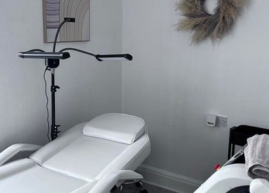 Relaxing treatment room at Pure Glow Clinic, Worthing, England, GB, featuring a modern reclining chair.
