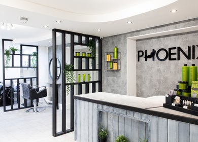 Chic interior of Phoenix Hair & Beauty, Wigan, England, showcasing modern styling spaces and products.