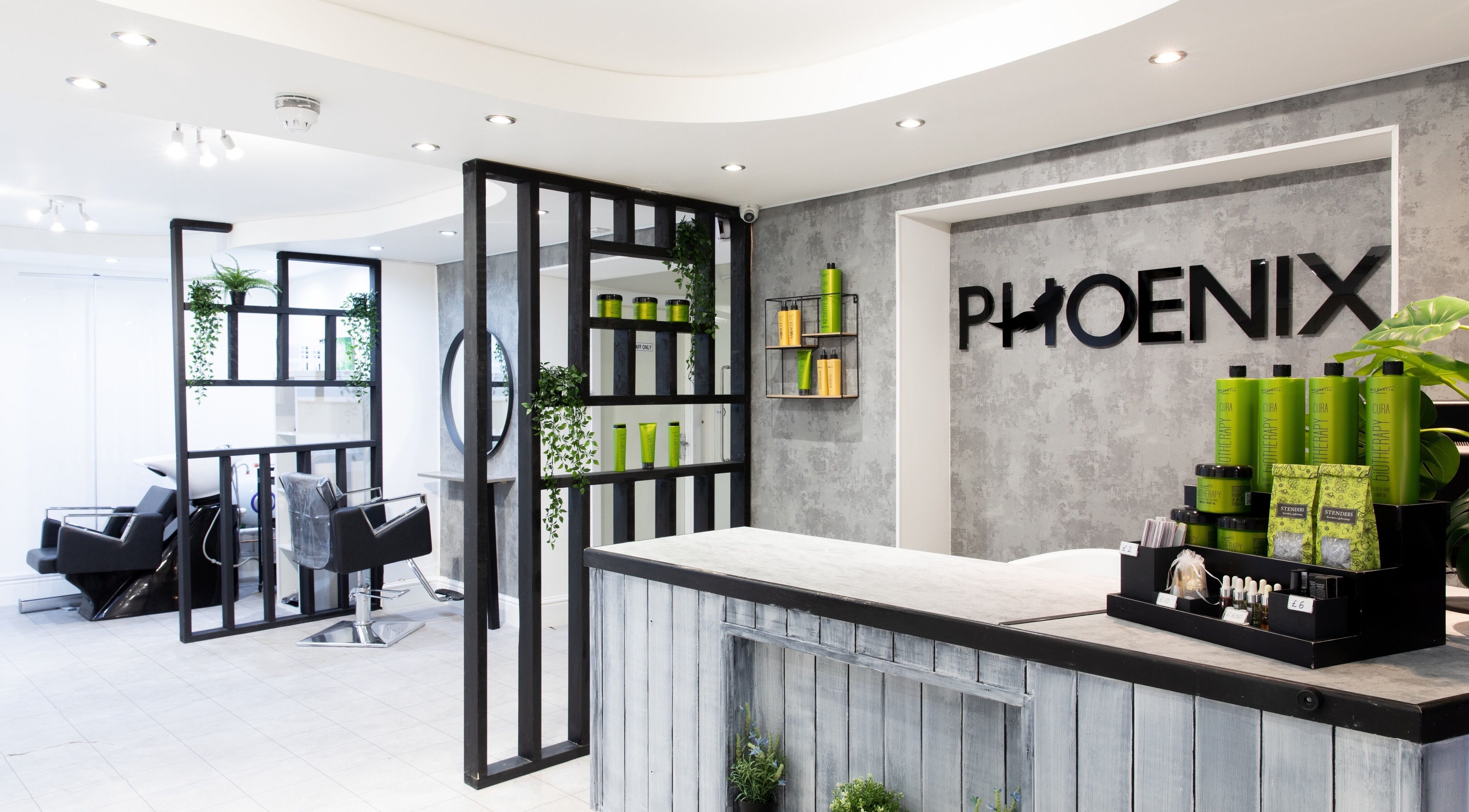 Chic interior of Phoenix Hair & Beauty, Wigan, England, showcasing modern styling spaces and products.