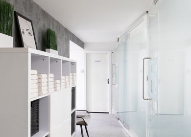 Tranquil hallway at Phoenix Hair & Beauty, Wigan, England, GB with modern decor and glass doors.