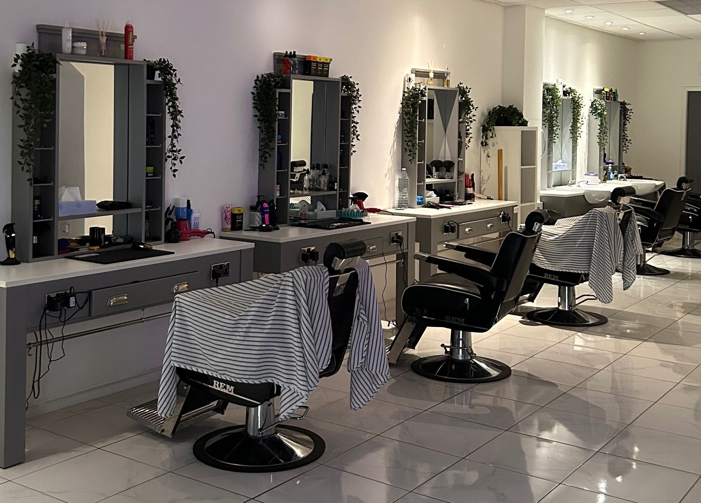 Modern barber chairs and stylish mirrors at House Of Luxxe Barbers Ltd, Yate, England, GB.