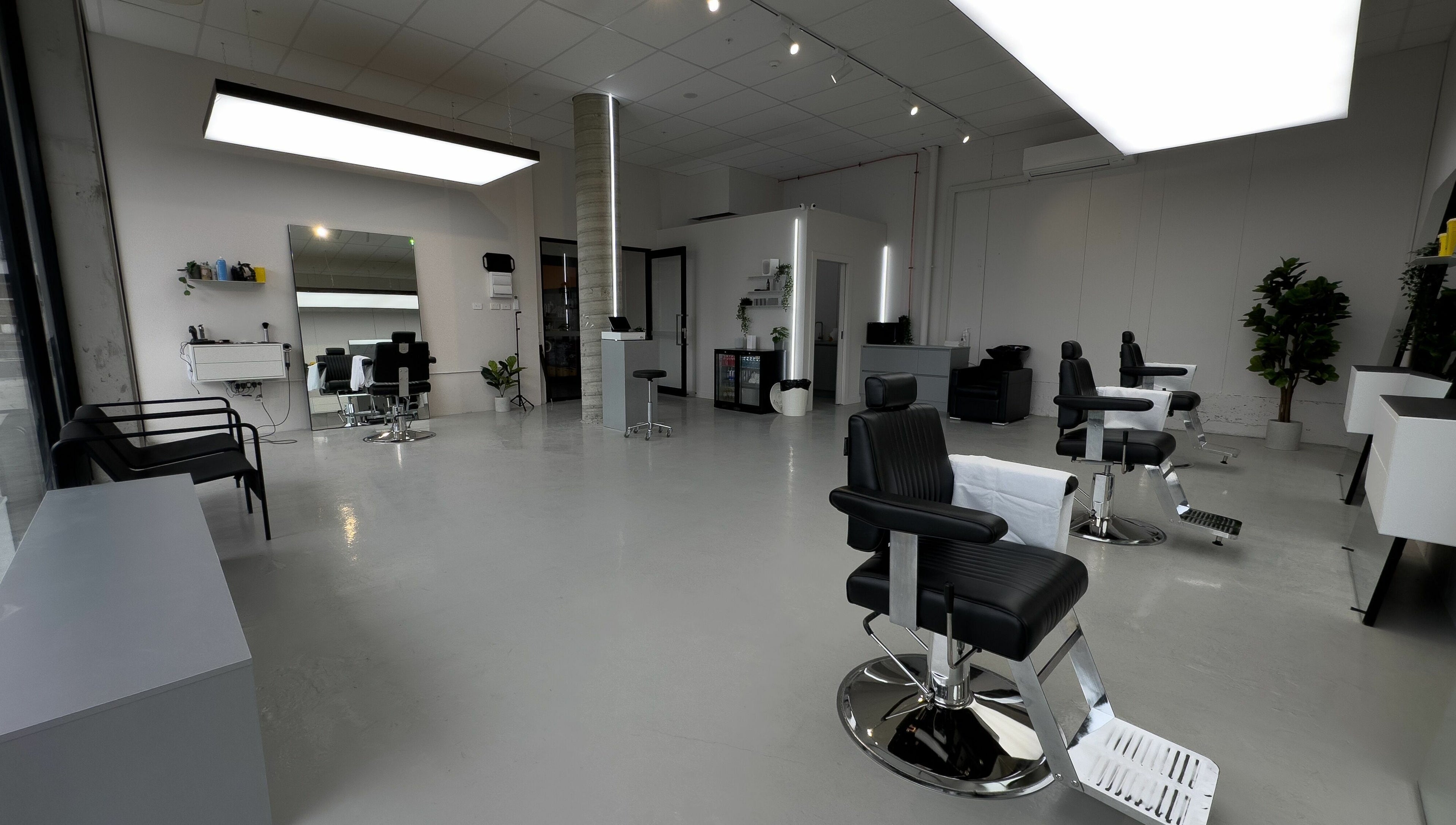 Spacious and modern salon interior at Studio Zero Essendon, Melbourne, Victoria, AU, with sleek black chairs.