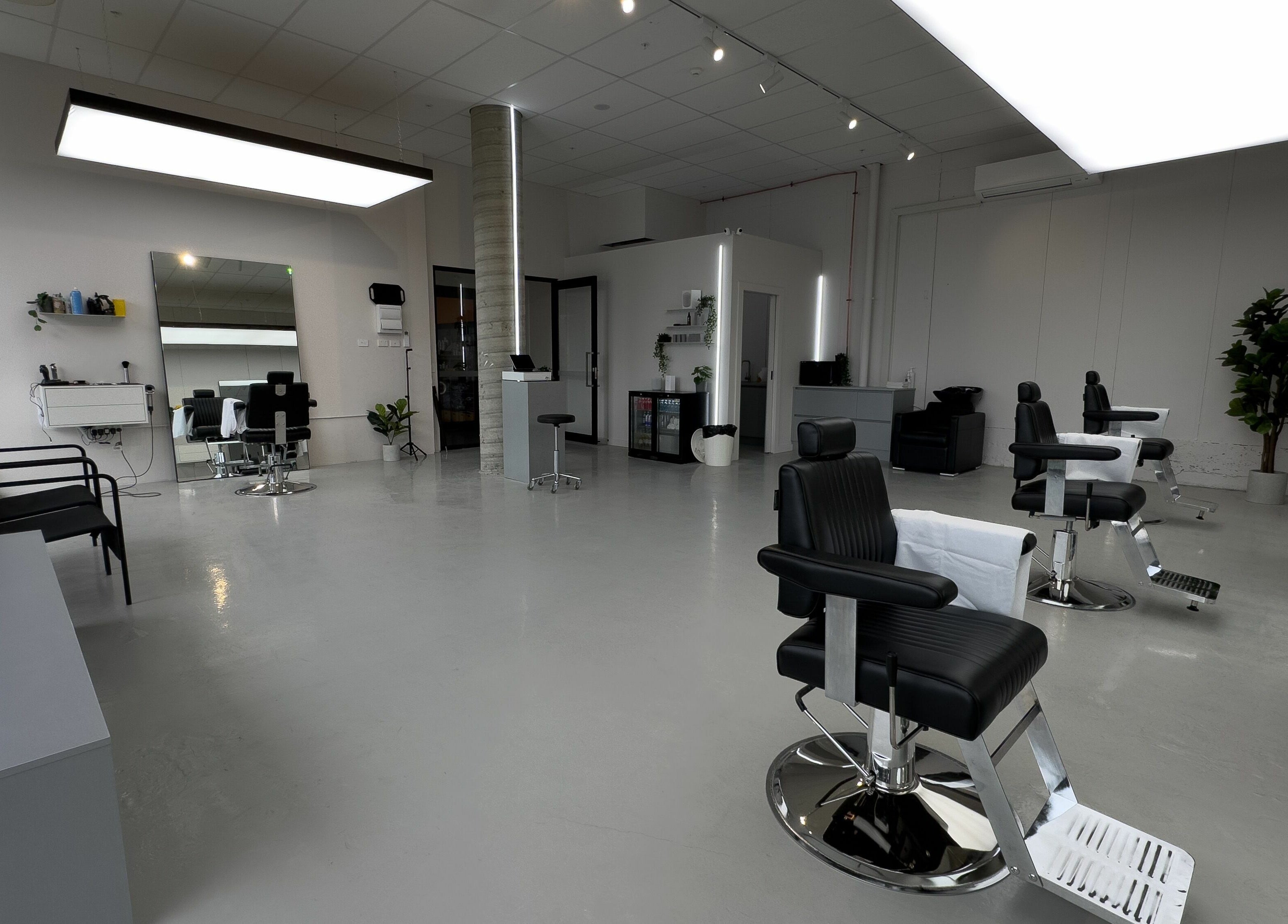 Spacious and modern salon interior at Studio Zero Essendon, Melbourne, Victoria, AU, with sleek black chairs.