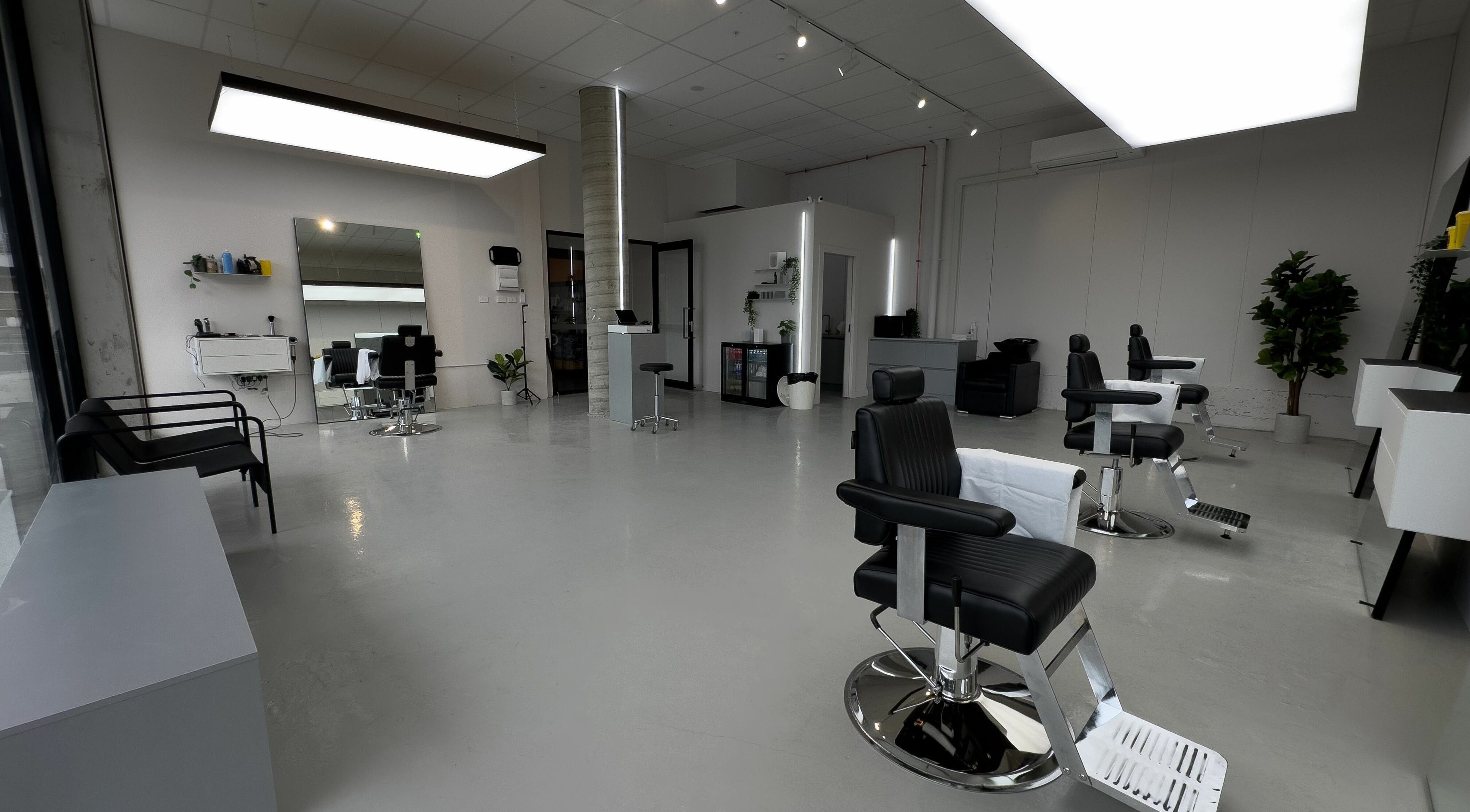 Spacious and modern salon interior at Studio Zero Essendon, Melbourne, Victoria, AU, with sleek black chairs.