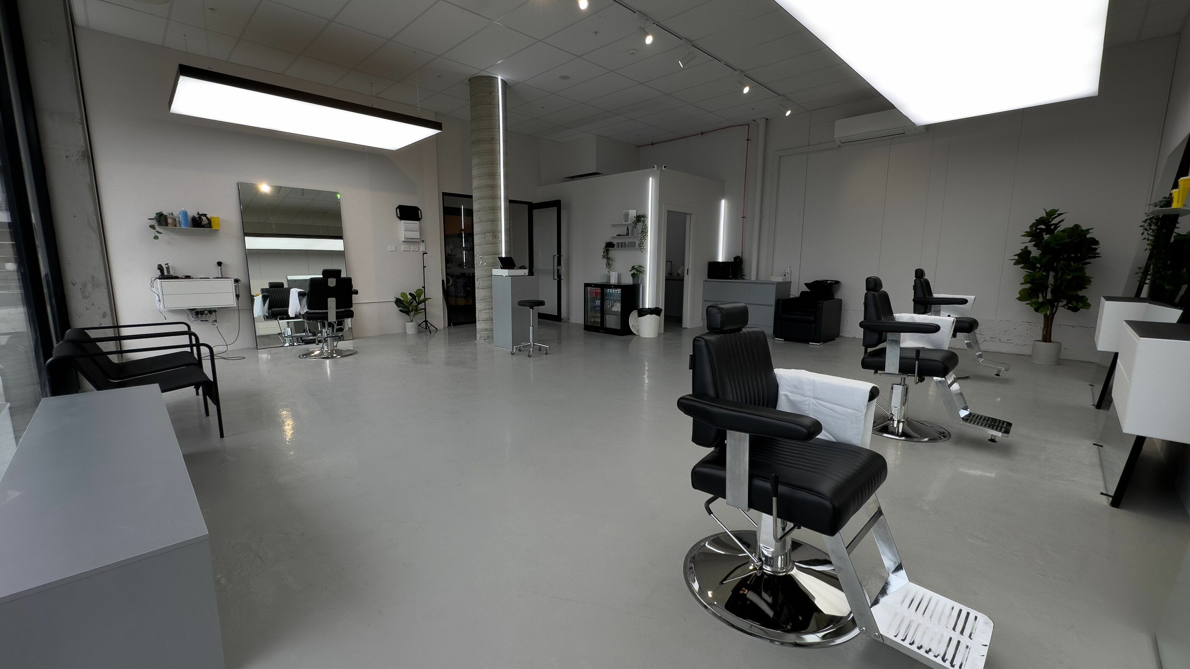 Spacious and modern salon interior at Studio Zero Essendon, Melbourne, Victoria, AU, with sleek black chairs.