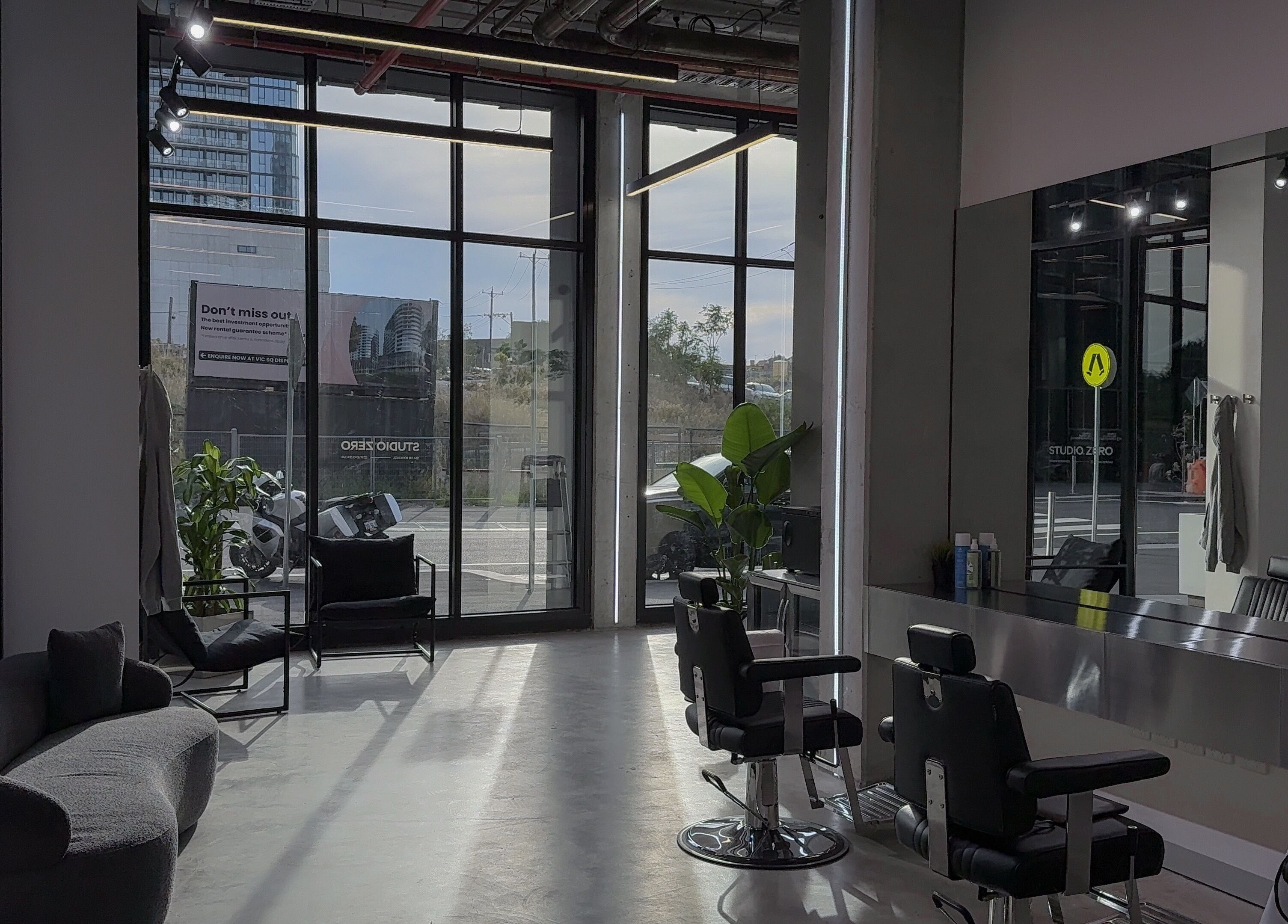 Modern interior of Studio Zero Footscray in Melbourne, Victoria, AU with chic seating and styling stations.