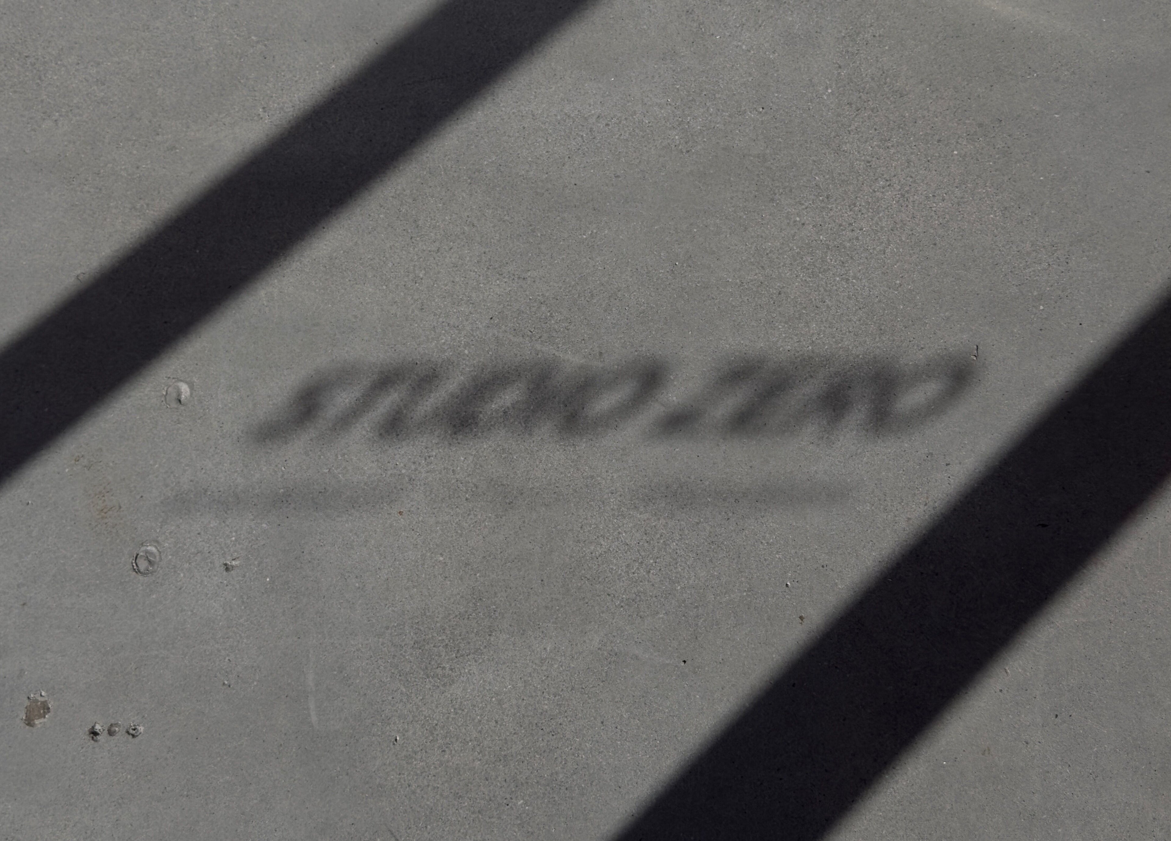 Shadow on floor spelling 'Studio Zero Footscray' at Melbourne, Victoria, AU.