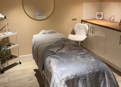 A massage room at Simply Beauty Norwich, Norwich, England, GB featuring a cozy bed and soothing decor.