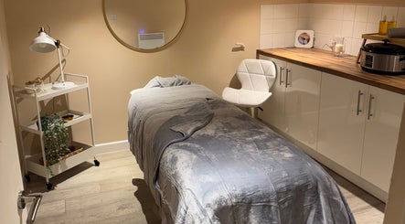 A massage room at Simply Beauty Norwich, Norwich, England, GB featuring a cozy bed and soothing decor.