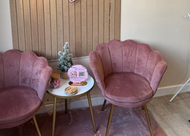 Cozy seating area at Simply Beauty Norwich, featuring pink chairs and modern decor in Norwich, England, GB.