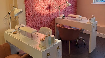 Elegant nail salon interior with pink floral wall at Simply Beauty Norwich, Norwich, England, GB.