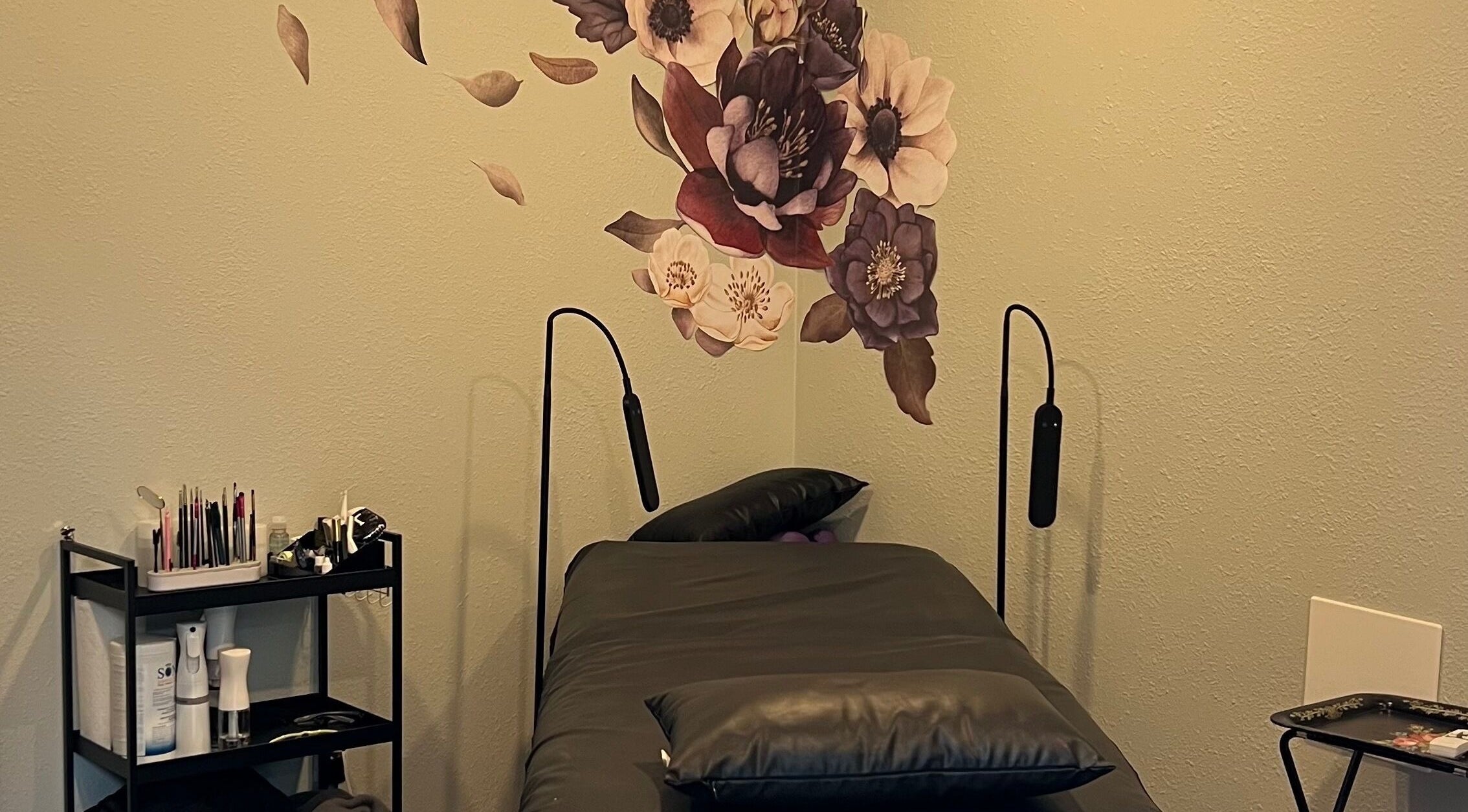 Tranquil treatment room at Moon Temple Esthetics - North Admiral, Seattle, Washington, US with floral wall art.