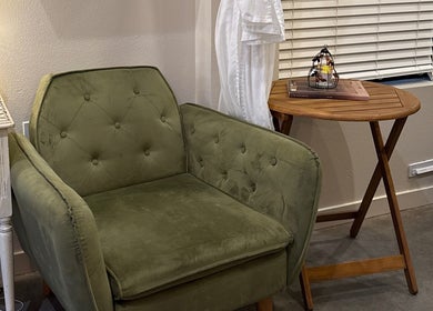 Elegant green chair in Moon Temple Esthetics - North Admiral, Seattle, Washington, US.
