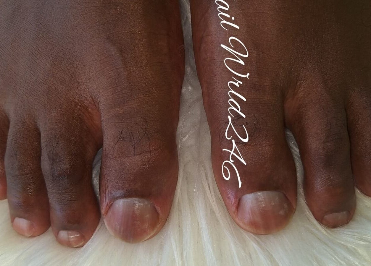 Close-up of pedicured toes at Nailwrld246, Saint James, BB, showcasing professional foot care.