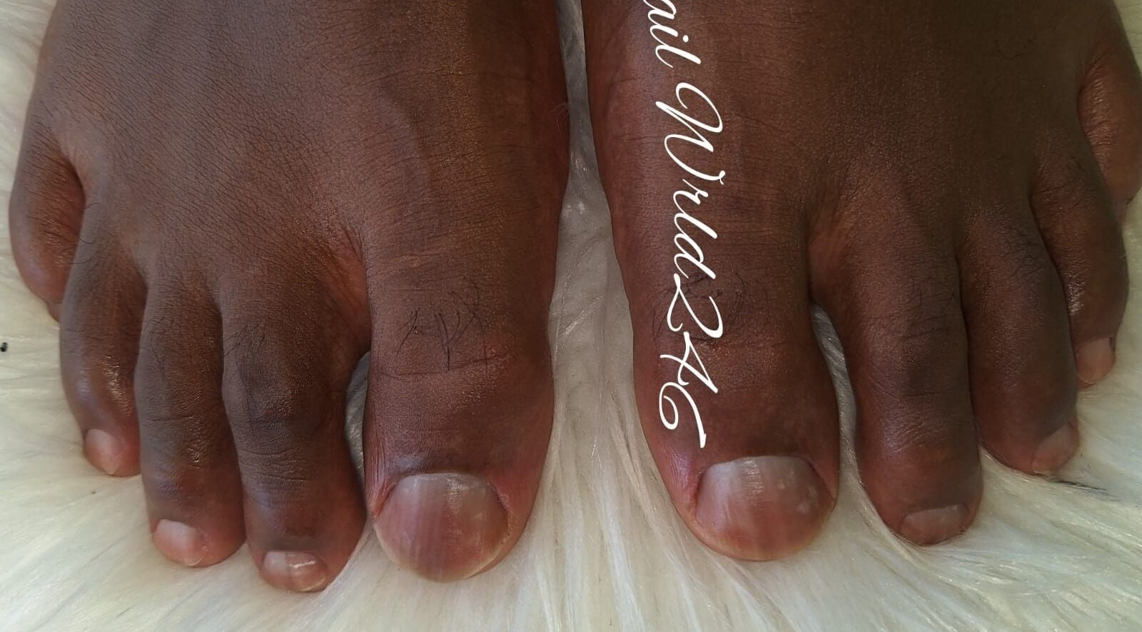 Close-up of pedicured toes at Nailwrld246, Saint James, BB, showcasing professional foot care.