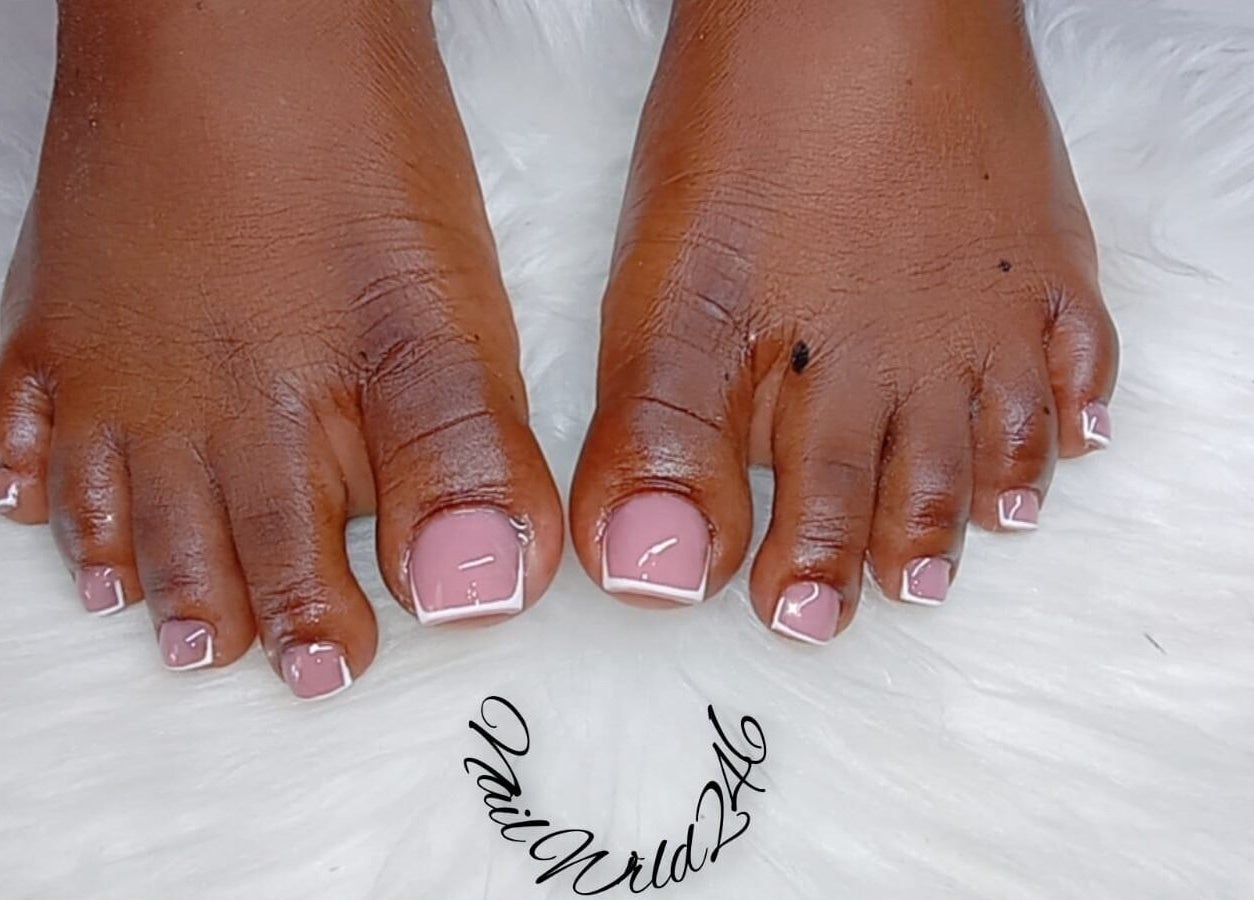 French pedicure at Nailwrld246 Saint James, Saint James, BB on white fur mat.