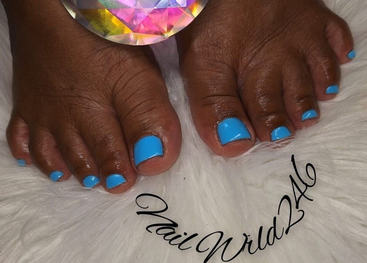 Blue polished toes on white fur at Nailwrld246, Saint James, Saint James, BB. Perfect pedicure showcase.