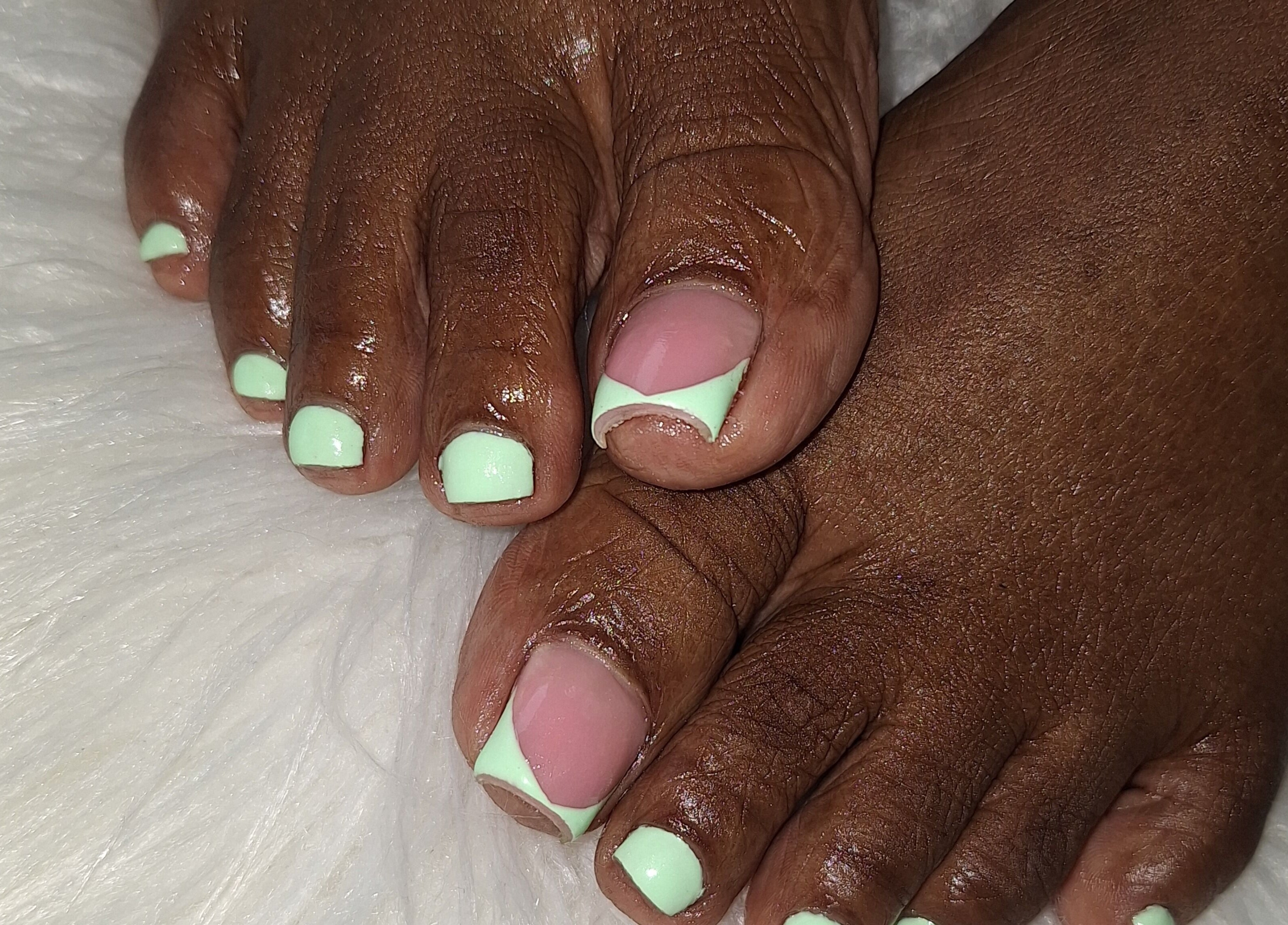 Mint green pedicure at Nailwrld246, Saint James, BB. Experience flawless toenail art designs and care.