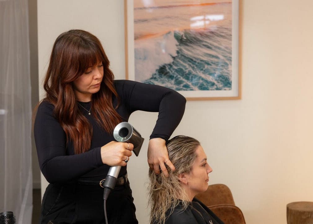 Stylist drying hair at That Girl Studio, St Kilda, Melbourne, Victoria, AU.