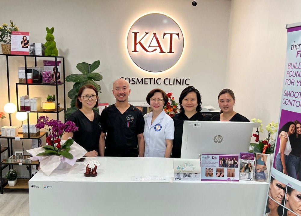 Team at reception desk of KAT Cosmetic Clinic in Cabramatta, New South Wales, AU, welcoming clients.