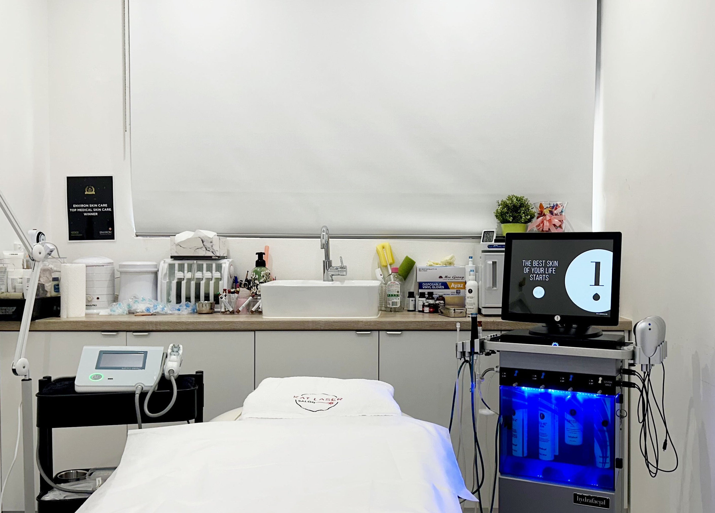 KAT Cosmetic Clinic treatment room in Cabramatta, New South Wales, AU with equipment and skincare products.
