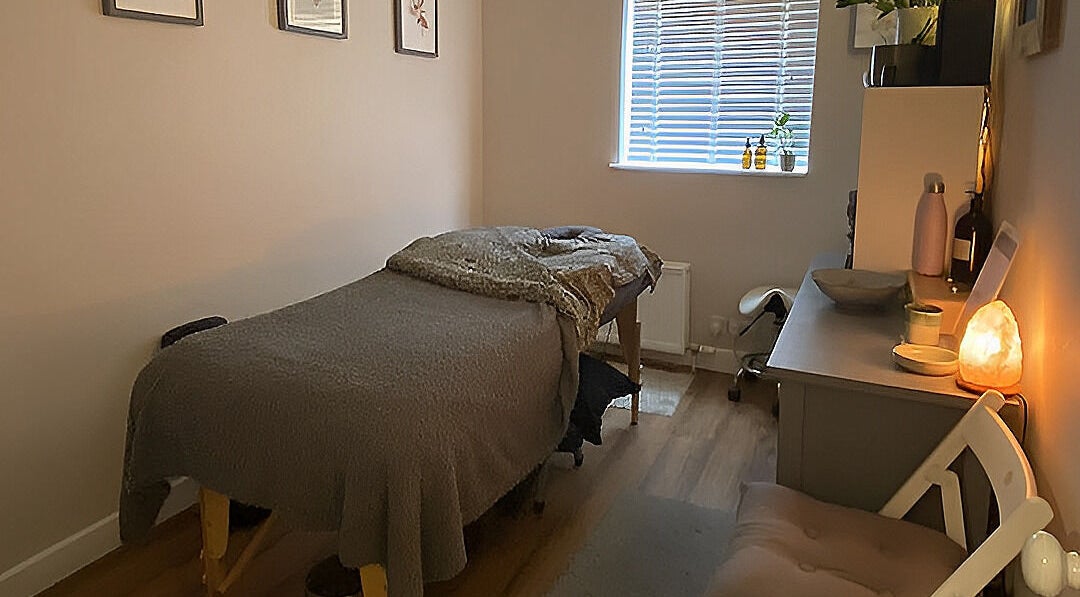 Cozy therapy room at Lucy Mather Holistic Therapy in Saxilby, England with massage table and warm lighting.