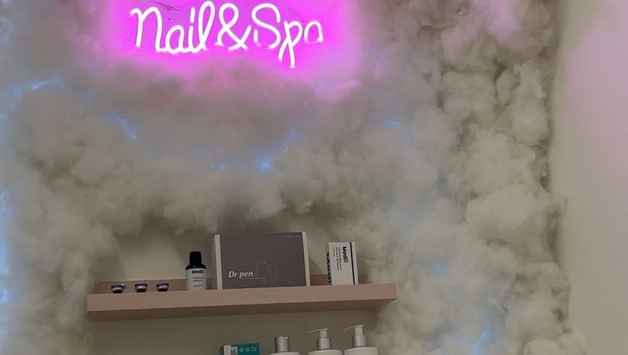 Neon Nail & Spa sign with cloud decor at Glowberry, Romford, England, GB, creating a serene ambiance.