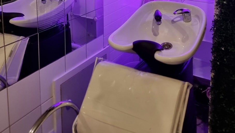 Modern salon wash basin at Hue of Aura, Timaru, Canterbury, NZ under soothing lavender lighting.