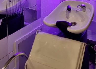 Modern salon wash basin at Hue of Aura, Timaru, Canterbury, NZ under soothing lavender lighting.
