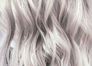 Wavy platinum blonde hair at Hue of Aura, Timaru, Canterbury, NZ, showcasing expert styling and color.