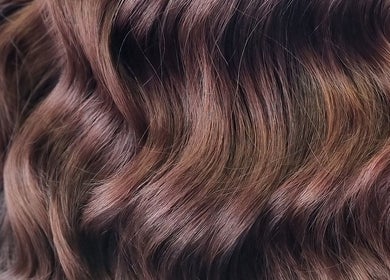 Rich brown wavy hair styled at Hue of Aura, Timaru, Canterbury, NZ for a luxurious salon experience.