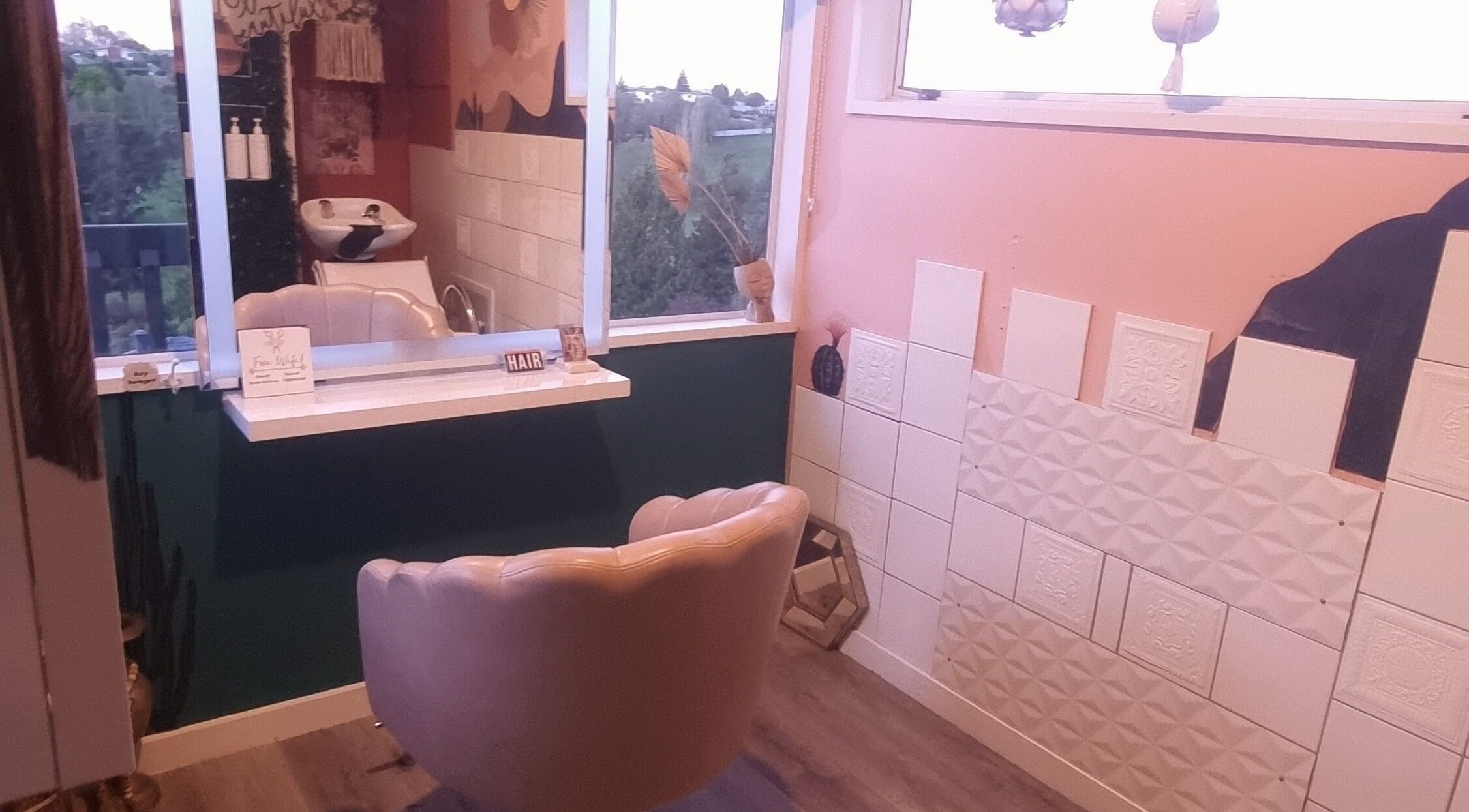 Stylish salon corner at Hue of Aura, Timaru, Canterbury, NZ with modern decor and scenic window view.