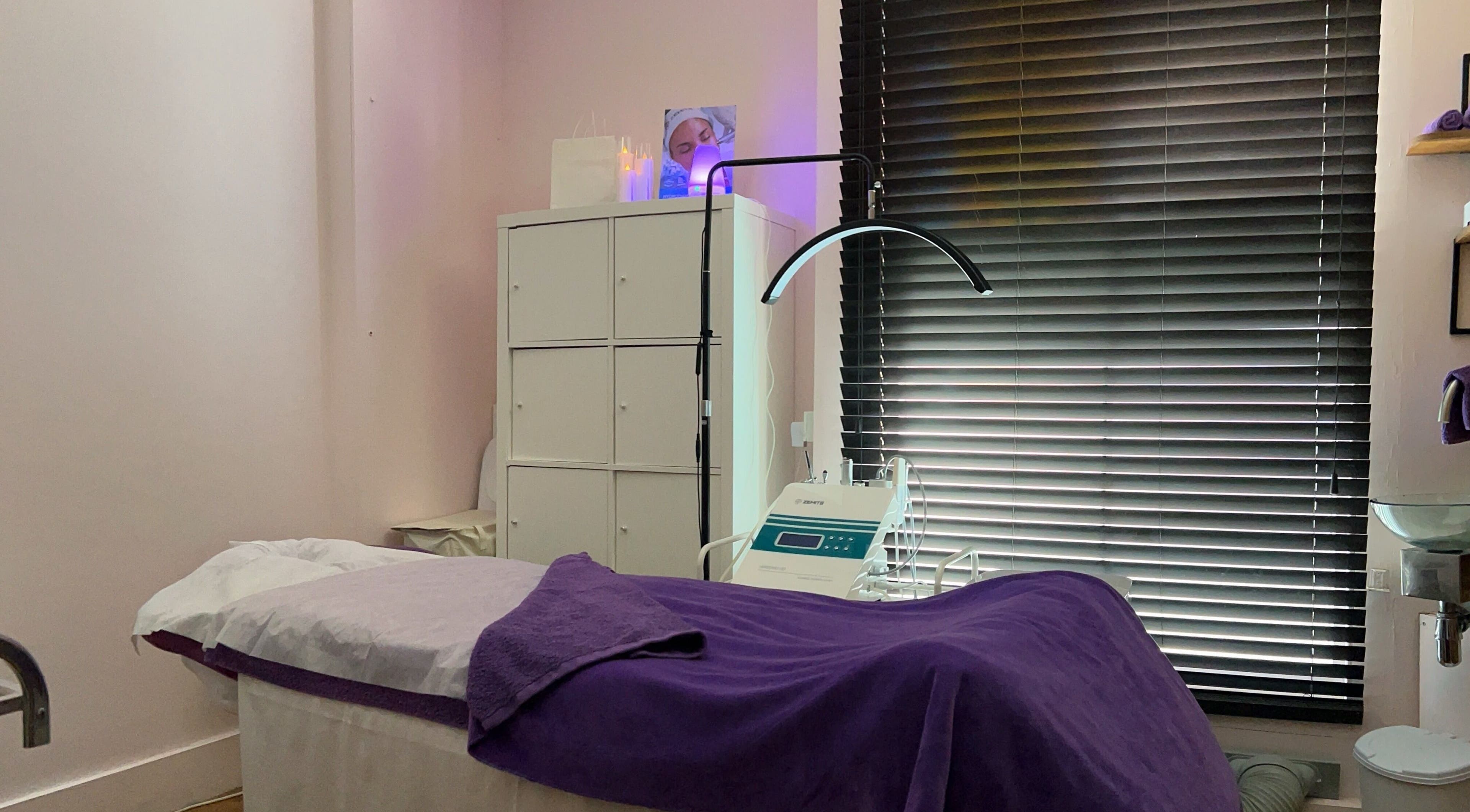 Serene treatment room at Pebble Beauty London, with a cozy bed and modern equipment in London, England, GB.