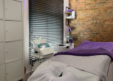 Cozy treatment room at Pebble Beauty London, featuring a comfortable massage table. London, England, GB.