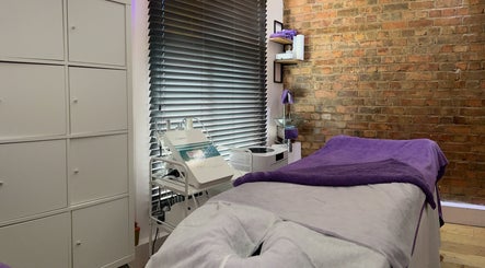 Cozy treatment room at Pebble Beauty London, featuring a comfortable massage table. London, England, GB.