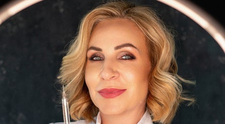 Smiling professional at Oanna Aesthetics, Corby, England, GB, showcasing beauty expertise.