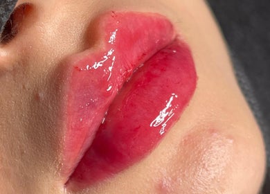 Closeup of glossy, vibrant lips at Oanna Aesthetics in Corby, England, GB, showcasing lip treatment.