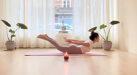 Woman practicing yoga with a candlelit ambiance at Soulful Therapy, Amsterdam, Noord-Holland, NL.
