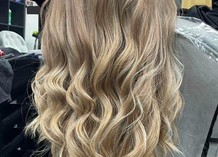 Luscious wavy blonde hair styling at Dream Studio 97 - Hounslow, England, GB in a salon setting.
