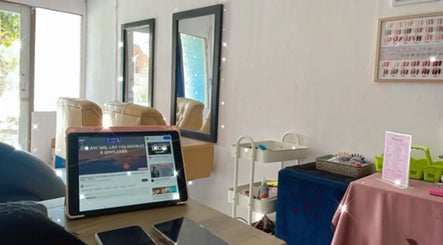 Cozy seating at MK Studio Kendari, Sulawesi Tenggara, with beauty tools and mirrors in the background.