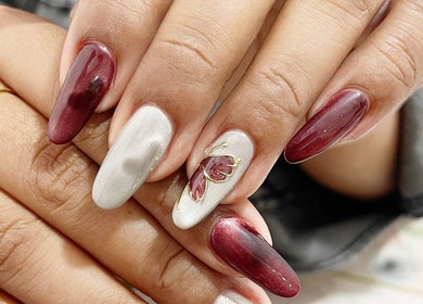 Elegant nail art design at MK Studio Kendari, Sulawesi Tenggara, ID featuring maroon and silver accents.