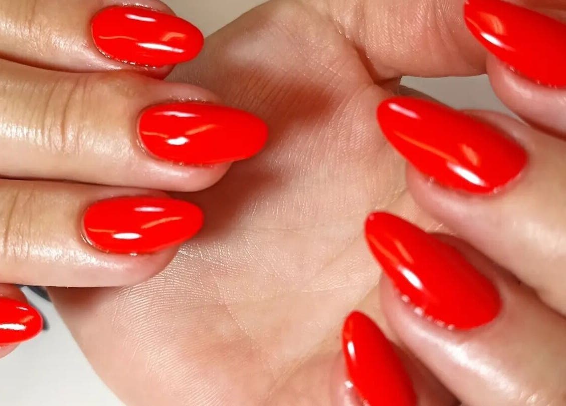Vibrant red manicure at Tranquility C Salon, Krugersdorp, Gauteng, ZA showcasing elegant nail art.