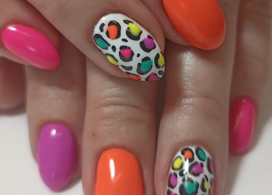 Colorful leopard print nails at Tranquility C Salon in Krugersdorp, Gauteng, ZA, showcasing vibrant nail art.